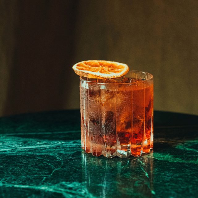 Negroni cocktail on green table