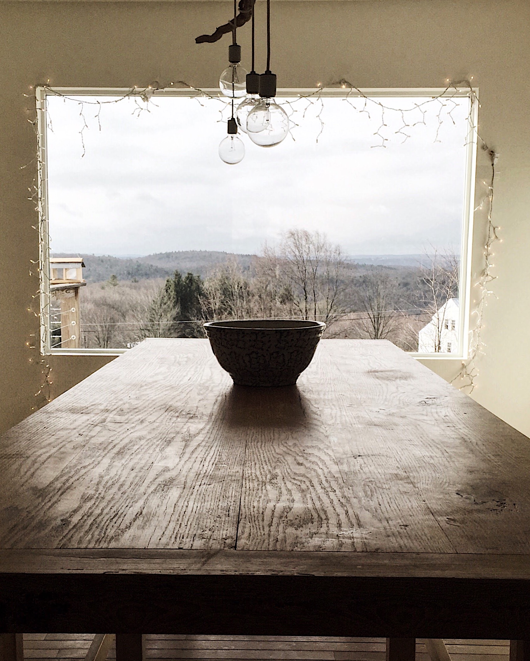 Window with a view and wooden table inside with decoration